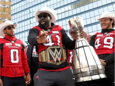 Calgary Stampeders Cordarro Law with the cup as thousands of fans turned out for a rally celebrating the Calgary Stampeders victory in the 106th Grey Cup outside city hall in Calgary on Tuesday, Nov. 27, 2018.