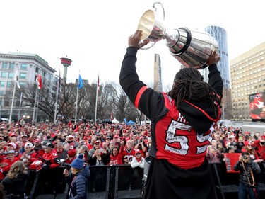 Calgary Stampeders Randy Richards hoists the cup as thousands of fans turned out for a rally celebrating the Calgary Stampeders victory in the 106th Grey Cup outside city hall in Calgary on Tuesday, Nov. 27, 2018.