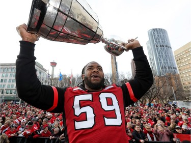 Calgary Stampeders Randy Richards hoists the cup as thousands of fans turned out for a rally celebrating the Calgary Stampeders victory in the 106th Grey Cup outside city hall in Calgary on Tuesday, Nov. 27, 2018.