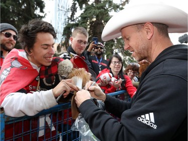 The Calgary Stampeders Head Coach Dave Dickenson signs autographs as thousands of fans turned out for a rally celebrating the Calgary Stampeders victory in the 106th Grey Cup outside city hall in Calgary on Tuesday, Nov. 27, 2018.
