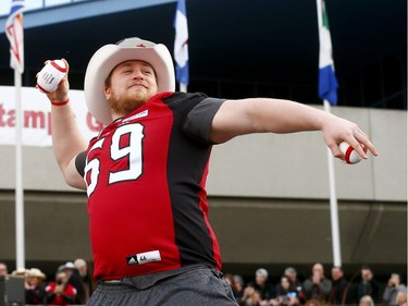 Calgary Stampeders Quinn Smith tosses footballs into the crowd as thousands of fans turned out for a rally celebrating the Calgary Stampeders victory in the 106th Grey Cup outside city hall in Calgary on Tuesday, Nov. 27, 2018.