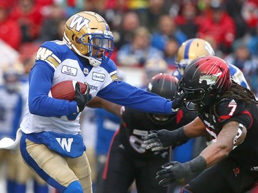Winnipeg Blue Bombers RB Nic Demski (L) runs the ball and is defended by Stamps Junior Turner (7) during the CFL Western Final in Calgary at McMahon Stadium on Sunday, November 18, 2018. Jim Wells/Postmedia