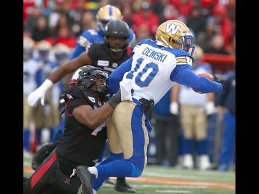 Winnipeg Blue Bombers RB Nic Demski (10) runs the ball and is tackled by Stamps Junior Turner (7) during the CFL Western Final in Calgary at McMahon Stadium on Sunday, November 18, 2018.  Jim Wells/Postmedia