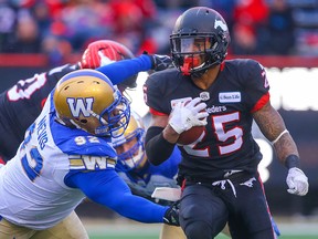 Calgary Stampeders Don Jackson avoids a tackle by Drake Nevis of the Winnipeg Blue Bombers during the 2018 CFL Western Final in Calgary on Sunday, November 18, 2018.