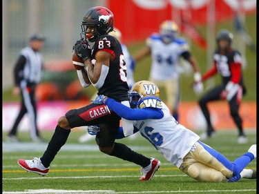 Calgary Stampeders Markeith Ambles, left is tackled by Winnipeg Blue Bombers Marcus Sayles in the CFL Western Final at McMahon Stadium in Calgary, on Sunday November 18, 2018. Leah hennel/Postmedia