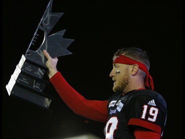 Calgary Stampeders quarterback Bo Levi Mitchell with the Western Final trophy after their win against the Winnipeg Blue Bombers  in the CFL Western Final at McMahon Stadium in Calgary, on Sunday November 18, 2018. Leah hennel/Postmedia