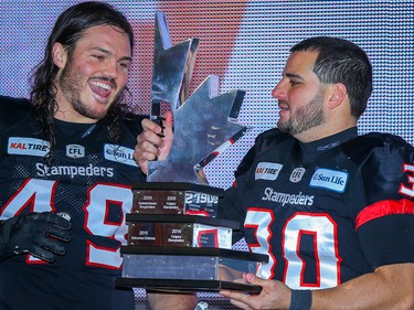 Calgary Stampeders Alex Singleton and Rene Paredes with the west final trophy after defeating the Winnipeg Blue Bombers in the 2018 CFL Western Final in Calgary on Sunday, November 18, 2018. Al Charest/Postmedia
