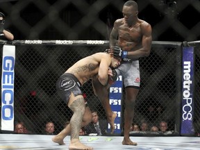 Brad Tavares, left, attempts to take down Israel Adesanya in The Ultimate Fighter 27 Finale middleweight main event bout at the Palms casino-hotel in Las Vegas, Friday, July 6, 2018. (Erik Verduzco/Las Vegas Review-Journal via AP)