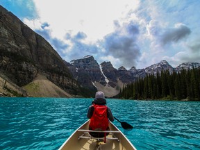 Canoeing in Moraine Lake in Banff National Park, Alberta's tourism gem.