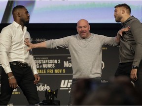 UFC president Dana White, center, breaks up Jon Jones, left, and Alexander Gustafsson during a news conference talking about their light heavyweight mixed martial arts bout, Friday, Nov. 2, 2018, at Madison Square Garden in New York. Jones and Gustafsson are to fight in UFC 232, which is scheduled for Dec. 29, 2018, in Las Vegas.