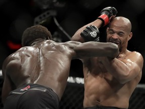 Jared Cannonier, left, lands a punch on David Branch during the second round of a middleweight mixed martial arts bout at UFC 230, Saturday, Nov. 3, 2018, at Madison Square Garden in New York. (AP Photo/Julio Cortez)