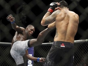 Israel Adesanya, left, kicks Brad Tavares in The Ultimate Fighter 27 Finale middleweight main event bout at the Palms casino-hotel in Las Vegas, Friday, July 6, 2018.