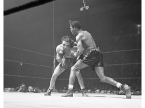 FILE - In this Feb. 23, 1945, file photo, Jake LaMotta, left, of the Bronx borough of New York, and Ray Robinson of the Harlem section of New York, fight at Madison Square Garden in New York. Robinson won the fight on a decision. LaMotta fought Sugar Ray Robinson six times, handing Robinson his first defeat. LaMotta, whose life was depicted in the film "Raging Bull," died Tuesday, Sept. 19, 2017, at a Miami-area hospital from complications of pneumonia. He was 95.