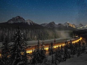 In this file photo taken on December 6, 2013, a cargo train passes through the famous 'Morant's Curve' on the Bow River at Banff National park near Lake Louise, Canada.