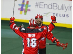 Calgary Roughnecks Dane Dobbie, right, and celebrate a goal on Vancouver Warriors goalie Aaron Bold during their game at the Scotiabank Saddledome in Calgary, on Saturday December 15, 2018. Leah Hennel/Postmedia