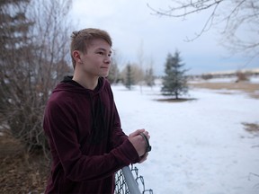 Ethan English, 16, tried to stop a coyote from killing his family's dog Jaks outside their home in Airdrie. Leah Hennel/Postmedia