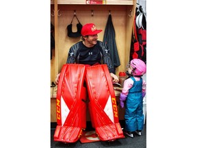 Calgary Flames goalie Mike Smith takes his daughter Kingsley, 2, into the dressing room after skating at the Saddledome in Calgary, on Friday December 21, 2018. Leah Hennel/Postmedia