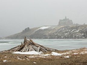 A stack of driftwood and the Prince of Wales Hotel in blowing snow at Waterton Lakes National Park on Tuesday, December 11, 2018. Mike Drew/Postmedia