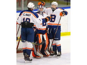 Saskatoon Blazers goalie Brett Mirwald celebrates with teammates after a 3-0 win over Rocky Mountain RoughRiders during the Mac's AAA hockey tournament at Max Bell Centre on Friday. Photo by Al Charest / Postmedia