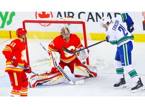 Calgary Flames goalie David Rittich makes a save on a shot by Loui Eriksson of the Vancouver Canucks during NHL hockey at the Scotiabank Saddledome in Calgary on Saturday, December 29, 2018. Al Charest/Postmedia