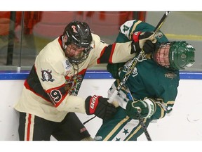 Calgary Northstars Patrick Forde (R) takes a shot on chin from Red Deer Optimist Chiefs Cole Muir (L) during a battle on the end boards during AAA Mac's Midget Hockey Tournament action at Max Bell Arena in Calgary on Saturday. Photo by Jim Wells/Postmedia.