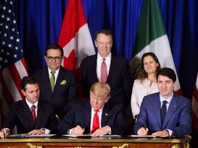Prime Minister Justin Trudeau, right to left, Foreign Affairs Minister Chrystia Freeland, United States Trade Representative Robert Lighthizer, President of the United States Donald Trump, Mexico's Secretary of Economy Ildefonso Guajardo Villarreal, and President of Mexico Enrique Pena Nieto participate in a signing ceremony for the new United States-Mexico-Canada Agreement in Buenos Aires, Argentina, on Friday, Nov. 30, 2018.