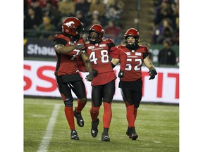 Calgary Stampeders Wynton McManis (48) celebrates a tackle with teammates Junior Turner (7) and Riley Jones (52) during play against the Ottawa Redblacks in the 106th Grey Cup game on Sunday, Nov. 25, 2018, in Edmonton.