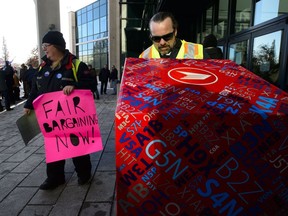 Canada Post rural suburban mail carrier Anita Baric, right, rallies outside Canada Post headquarters prior to Canada Post hosting its Annual Public Meeting in Ottawa on Wednesday, Dec. 12, 2018.