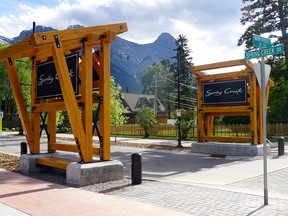 The Spring Creek Mountain Village signs stand at the corner of Main Street and Spring Creek Drive in Canmore, Alberta.