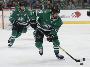 In this Oct. 21, 2017, file photo, Dallas Stars wing Jamie Benn skates the puck upice as center Tyler Seguin trails during the first period of an NHL hockey game against the Carolina Hurricanes in Dallas.