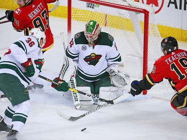 Matthew Tkachuk looks to grab a rebound in front of Minnesota Wild goaltender Alex Stalock during NHL action at the Scotiabank Saddledome in Calgary on Thursday December 6, 2018.