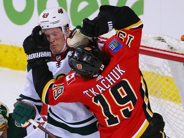 The Calgary Flames' Matthew Tkachuk and the Minnesota Wild's Ryan Suter collide in the crease during NHL action at the Scotiabank Saddledome in Calgary on Thursday December 6, 2018.