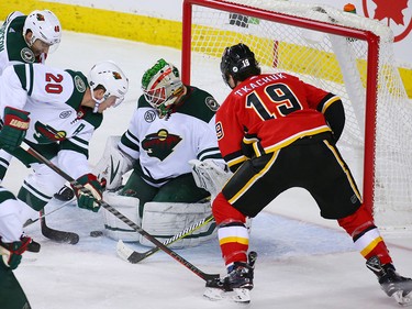 Matthew Tkachuk looks to grab a rebound in front of Minnesota Wild goaltender Alex Stalock during NHL action at the Scotiabank Saddledome in Calgary on Thursday December 6, 2018.