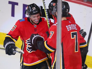 Johnny Gaudreau, Elias Lindholm and T.J. Brodie celebrate after Lindholm scored and Gaudreau assisted during NHL action against the Minnesota Wild at the Scotiabank Saddledome in Calgary on Thursday December 6, 2018.