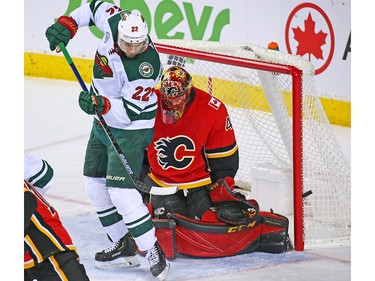 Calgary Flames goaltender Mike Smith stops this Minnesota Wild scoring chance with the Wild's Nino Niederreiter during NHL action at the Scotiabank Saddledome in Calgary on Thursday December 6, 2018.