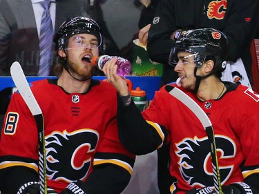 Johnny Gaudreau squirts gatorade into Elias Lindholm's mouth after Lindholm scored and Gaudreau assisted during NHL action against the Minnesota Wild at the Scotiabank Saddledome in Calgary on Thursday December 6, 2018.