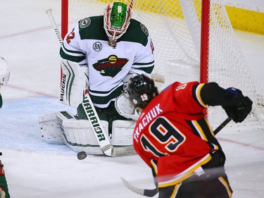 Matthew Tkachuk gets a shot on Minnesota Wild goaltender Alex Stalock during NHL action at the Scotiabank Saddledome in Calgary on Thursday December 6, 2018.