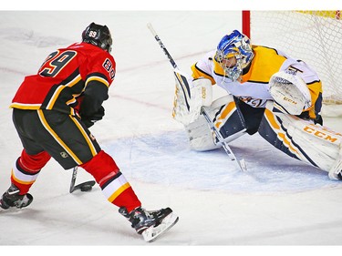 Calgary Flames centre Alan Quine lines up to score his first NHL goal on Nashville Predators goaltender Juuse Saros in NHL action at the Scotiabank Saddledome in Calgary on Saturday December 8, 2018.
