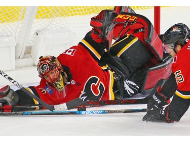Calgary Flames goaltender Mike Smith and Noah Hanifin stretch to stop this shot from the Nashville Predators' Ryan during NHL action at the Scotiabank Saddledome in Calgary on Saturday December 8, 2018.