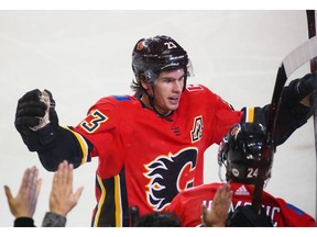 The Calgary Flames Sean Monahan celebrates assisting on Oliver Kylington's first NHL on Nashville Predators goaltender Juuse Saros during NHL action at the Scotiabank Saddledome in Calgary on Saturday. Photo by Gavin Young/Postmedia