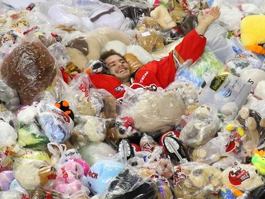 Calgary Hitmen forward Kaden Elder celebrates with the bears after he scored the first goal against the Kamloops Blazers in the Teddy Bear Toss game at the Scotiabank Saddledome on Sunday, December 9, 2018.