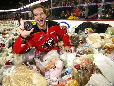 Calgary Hitmen Kaden Elder celebrates after scoring on Kamloops Blazers goalie Dylan Garand to start the bear toss during the 24th annual Brick Teddy Bear Toss game at the Scotiabank Saddledome in Calgary on Sunday December 9, 2018.