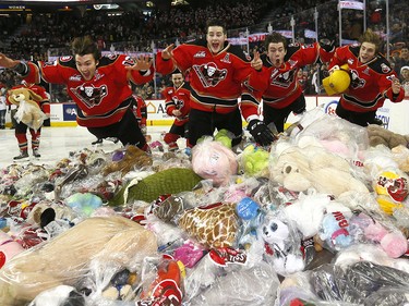 Calgary Hitmen have some fun with the thousands of teddy bears during the 24th annual Brick Teddy Bear Toss game against the Kamloops Blazers at the Scotiabank Saddledome in Calgary on Sunday December 9, 2018.