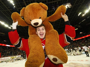 Calgary Hitmen Egor Zamula with the thousands of teddy bears during the 24th annual Brick Teddy Bear Toss game against the Kamloops Blazers at the Scotiabank Saddledome in Calgary on Sunday December 9, 2018.