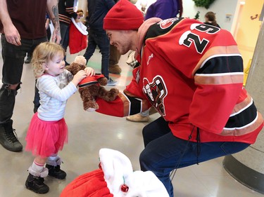 Calgary Hitmen forward Kaden Elder hands out teddy bears to kids at the Alberta Children's Hospital Monday, December 10, 2018. Hitmen players distributed some of the thousands of bears collected at Sunday's annual Brick Teddy Bear Toss game. Elder scored the first goal in the game to trigger the avalanche of stuffies.