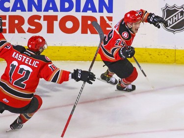 Calgary Hitmen forward Kaden Elder, right, celebrates after scoring on Kamloops Blazers goaltender Dylan Garand to claim the first goal in the Brick Teddy Bear Toss game at the Scotiabank Saddledome on Sunday, December 9, 2018.