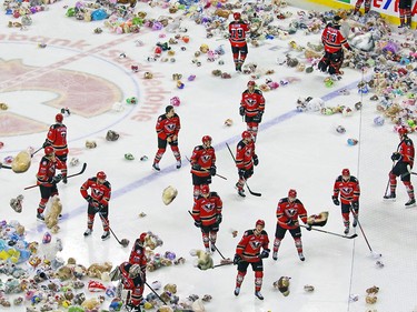 The Calgary Hitmen get belted with thousands of teddy bears during the 24th annual Brick Teddy Bear Toss game against the Kamloops Blazers at the Scotiabank Saddledome in Calgary on Sunday December 9, 2018.