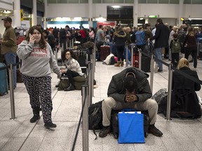 People wait in the departures area on Thursday, Dec. 20, 2018, after Gatwick Airport was closed after drones were spotted over the airfield.
