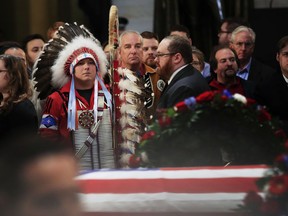 Native Americans Donald Woody, left, and Warren Stade of the Shakopee Mdewakanton Sioux Community tribe in Prior Lake, Minn., pay their last respects to former President George H.W. Bush as he lies in state at the U.S. Capitol in Washington, Tuesday, Dec. 4, 2018.
