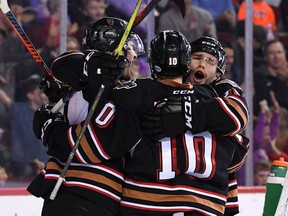 The Hitmen celebrate one of Kaden Elder's goals Sunday at the Saddledome.